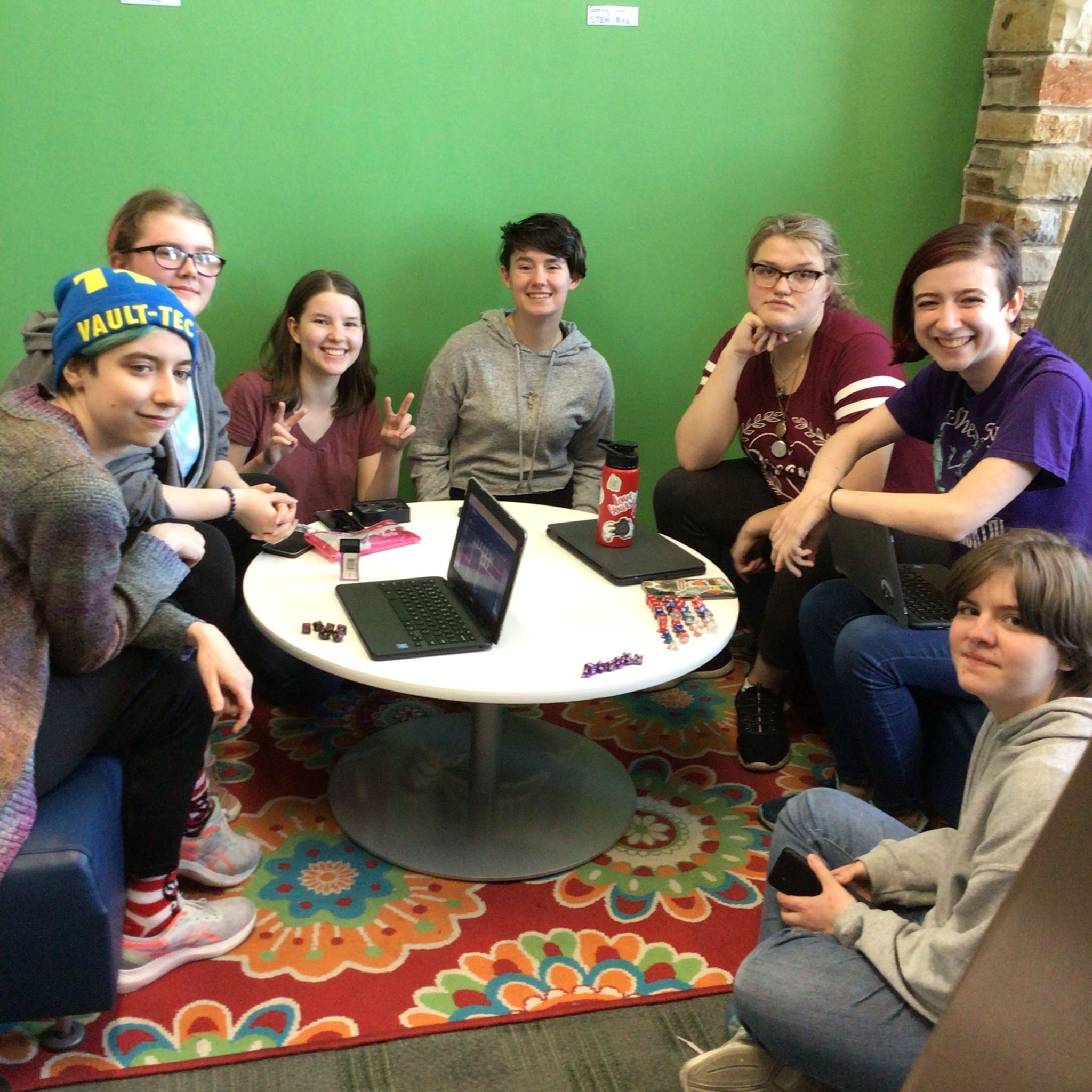 group of teens sitting around a coffee table in Teen Alley